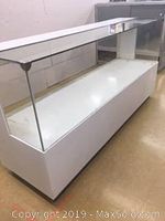 White display showcase cabinet with glass front and sides, white metal frame, shown from the front-left angle.