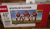 Front view of original RCA 49″ LED 4K Ultra HD TV box showing model, resolution and HDMI port count