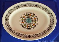 Photo of the oval ironstone platter showing the full Roulette pattern with colorful central motif and geometric border.
