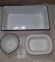 Top view of the three enamelware pieces showing interior surfaces and size references with lot number card.