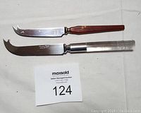 Front view of two cheese knives showing the handles and blades.