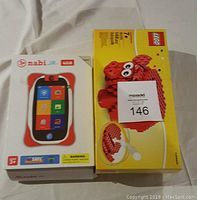 Nabi Jr 4GB Kids Tablet box next to unopened LEGO Classic Red Pig set box.