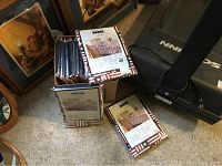 10 packed and shrink-wrapped tablecloths stacked in boxes showing packaging with stars and stripes.