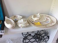 Photo showing full set of 8 Homer Laughlin Eggshell Nautilus china pieces, including large serving platters, small platter, gravy boat, gravy under plate, creamer, and sugar bowl