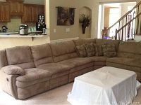 Front view of full curved sectional sofa and coffee table