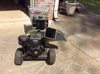 Full front view showing engine, hopper, wheels and frame