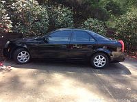 Side profile of black 2005 Cadillac CTS parked outdoors