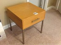 Side view of the small wood and metal desk table with a drawer showing design and condition.