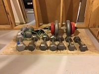 Overview of 13 fitness items including hex dumbbells, adjustable dumbbell bars with plates, and green resistance band