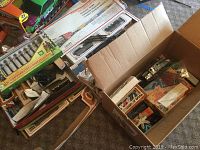 Photo showing assembled boxes of multiple train set items including tracks and accessories grouped together.