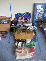 Pile of assorted bags including ABBACINO Mallorca purse, clutches, tote bags, and organizer visible on carpet floor with boxes and other items around.