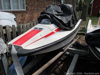 Front deck view showing white hull, red deck decal, black rub rail