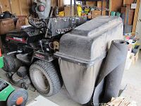 Right side and rear view showing mower deck, debris bag and rake attachment