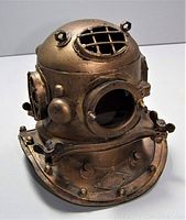 Angled front-side view showing the front viewport, hinged cover, and riveted detailing on the helmet.