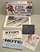 Silver Lightning cleaning kit and packaging laid out showing all components including instruction guide and promotional cards.