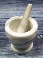 Mortar and pestle set front view showing details of marble texture and shape