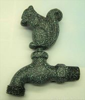Photo showing side view of the spigot with the squirrel figure on top and threaded ends for garden hose or pipe connection