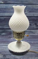 Full view of the lamp showing the white milk glass hobnail texture and scalloped edges on shade and base.
