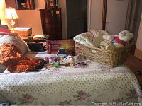 Photo showing the bed with the Willow Curve box, Avon products, basket with teddy bears, and comforter.