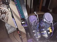 Image showing Rossignol skis, ski poles, boots, and part of the soft carry bag.
