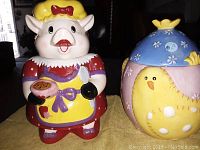 Photo showing two ceramic cookie jars: pig character in bonnet and dress holding cookie and spoon, and round chick with bonnet decorated with flowers.