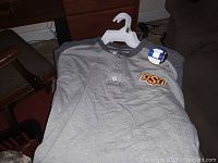 Gray OSU shirt size Large with henley neckline and embroidered logo on chest.