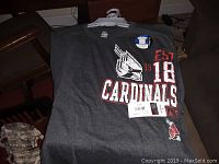 Photo of gray Cardinals shirt with cardinal bird logo, established date 1918, and Cardinals text, new with tags.