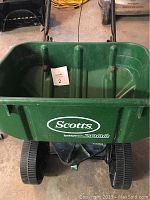 Front view of green Scotts Speedy Green 2000 spreader hopper with logo.