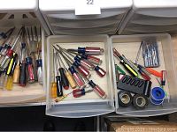 Drawers holding screwdrivers, electrical tape, and wire connectors.