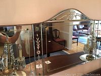 Front view of the full etched glass mirror showing floral etchings and scalloped top.