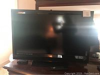 Front view of 36-inch Vizio flat screen television on stand.