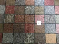 Top-down view showing overall rug pattern and condition, with lot tag visible
