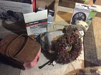 Wide shot of the lot showing picnic basket, waffle maker box, fryer, stock pot, wreath, portable fan, and space heater