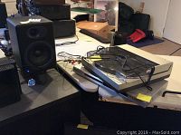 Overall view showing both Audioengine A5 speakers, Technics turntable on top of Sony CD/DVD player on table
