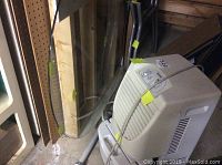 Kenmore dehumidifier and glass table top with metal base stored in basement area