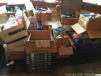 Wide view of all items showing boxes of yarn, plastic crates, picnic basket, and metal organizer.