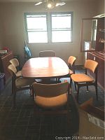 Overview of dining table and six chairs in room under window