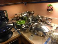 Overview of all cookware pieces arranged on countertop