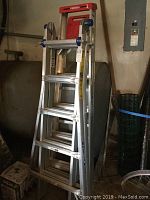 Photo of two Werner aluminum ladders stacked together, showing overall condition and size.