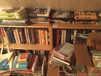Books arranged on shelves, including fiction, craft, and cookbooks