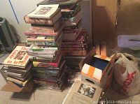 Overall lot of stacked books on floor including cookbooks, reference volumes and fiction