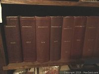 Spine view of seven hardbound Numismatist books covering years 1936, 1937, 1938, 1939, 1941, 1943, and 1947 to 1959.
