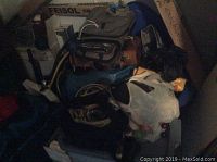 Overview of scuba gear bags with various smaller items and accessories packed in and around them.