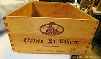 Front side of wooden wine crate showing Chateau La Vallière logo and text, dated 1982.