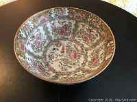 Top view of large Rose Medallion bowl showing intricate floral and bird design in pinks, greens, and gold inside the bowl.