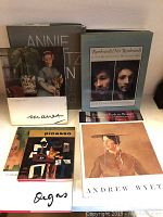 First photo shows seven art books stacked and standing, with visible titles including Annie, Rembrandt, Marx, Picasso, Degas, Andrew Wyeth.