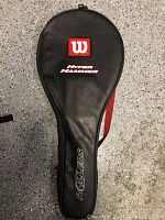 Top view of the black Wilson racket case showing the logo, model name Hyper Hammer, and Roller 6 label.