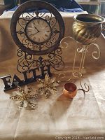 Photo showing Kirkland clock, Faith metal sign, two clip-on leopard print flowers, copper planter on cream stand, small copper bowl.