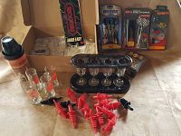 Full view of shooter glasses, recipe book, Jack Daniels tin, mixer, new darts packaging, and pour spouts.