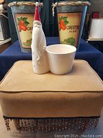 Beaded tan footstool with glass Santa planter on top, two metal Country Farm planters behind